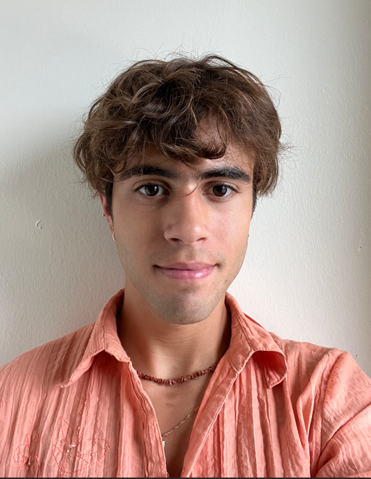 Image of young man in front of a light colored wall